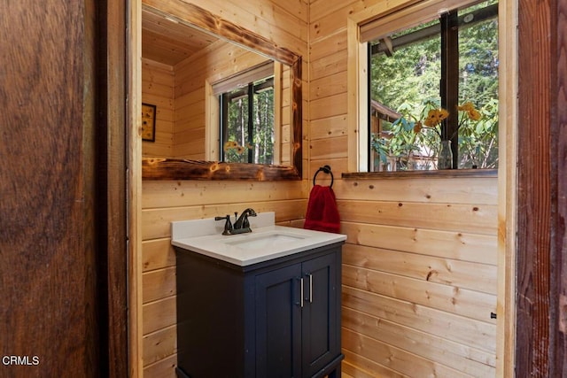 bathroom with vanity and wooden walls