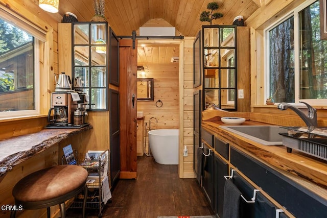 full bathroom featuring wood finished floors, wooden ceiling, wood walls, a freestanding bath, and vaulted ceiling