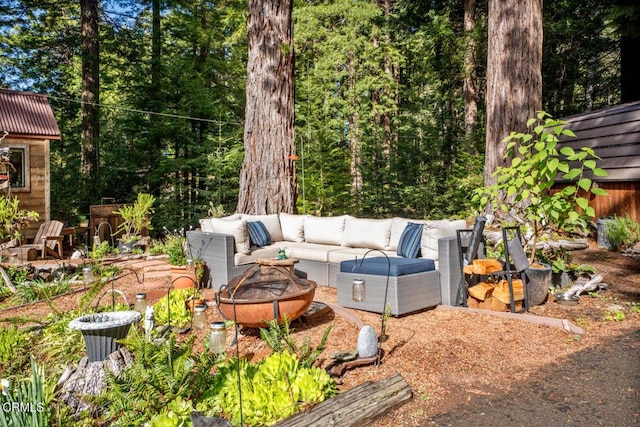 view of patio / terrace with an outdoor living space with a fire pit