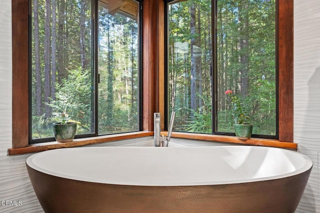 bathroom with a freestanding bath and a sink