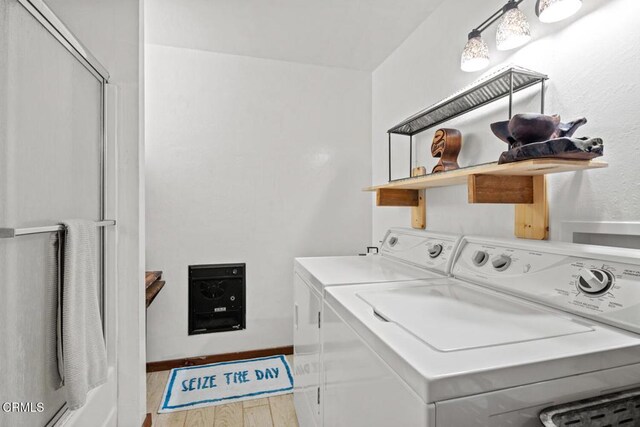 laundry area with laundry area, wood finished floors, and washing machine and clothes dryer