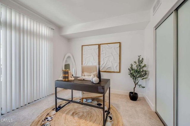 office featuring light colored carpet, visible vents, and baseboards