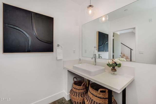 bathroom with baseboards and vanity