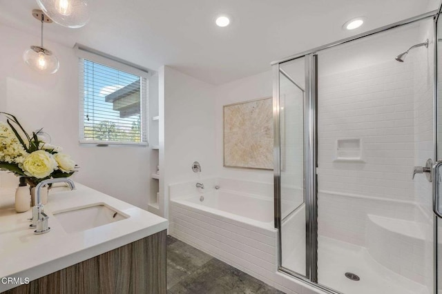 bathroom featuring a stall shower, a garden tub, a sink, and recessed lighting