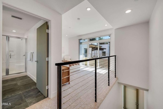 hallway featuring recessed lighting, baseboards, visible vents, and an upstairs landing