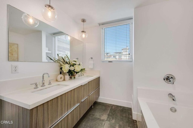 full bathroom with baseboards, double vanity, a sink, and a tub