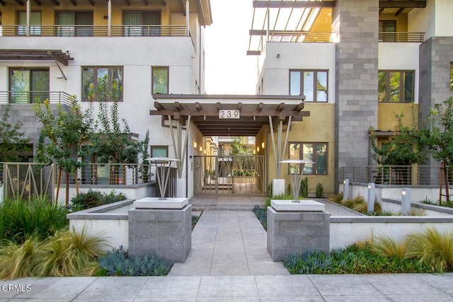 doorway to property featuring stucco siding