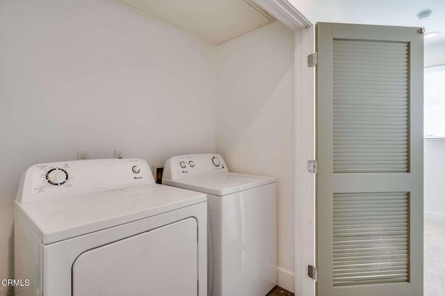 washroom featuring laundry area, attic access, baseboards, and separate washer and dryer