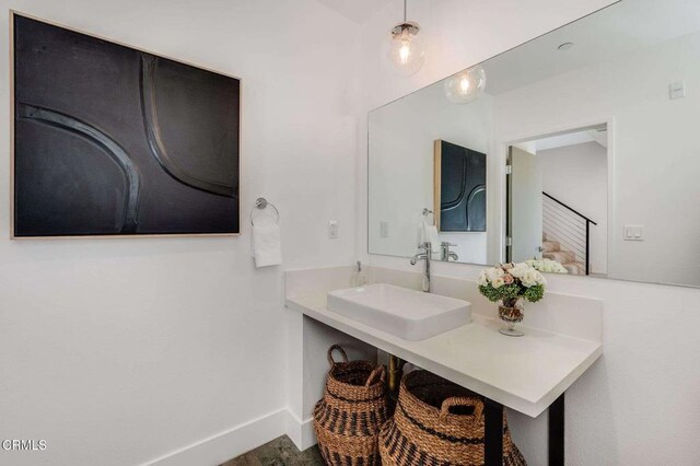 bathroom with baseboards and vanity