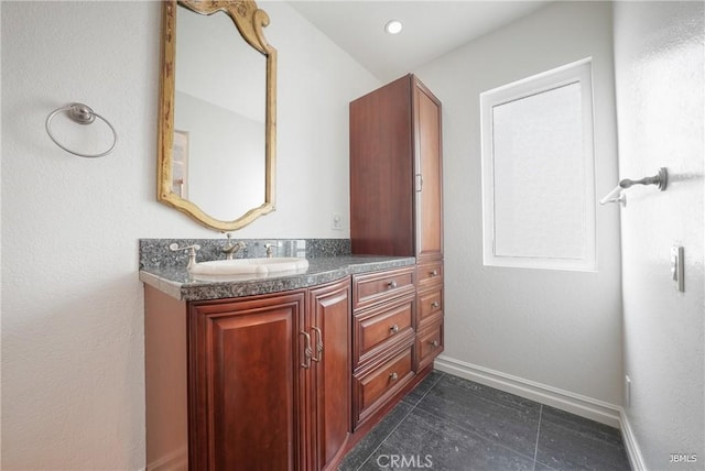 bathroom with tile patterned floors, recessed lighting, baseboards, and vanity