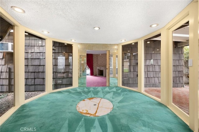 spare room featuring a textured ceiling, carpet, and recessed lighting