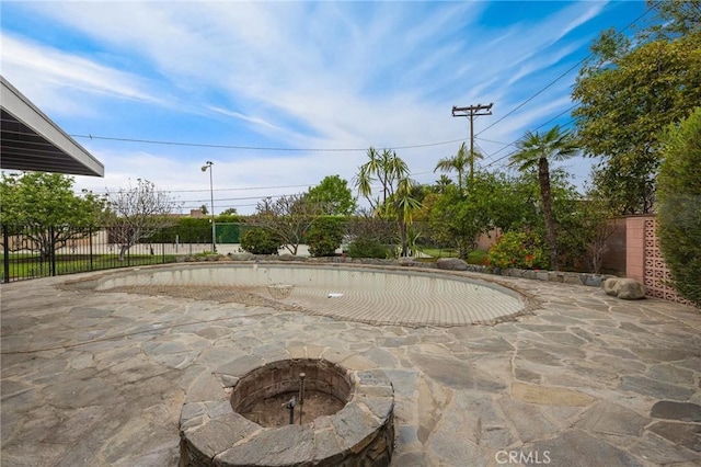 view of patio / terrace with an outdoor fire pit and a fenced backyard