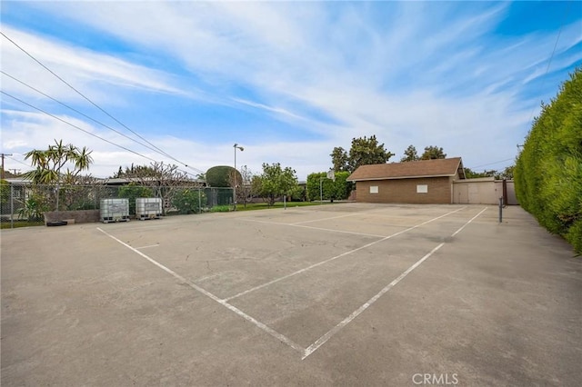 view of sport court with fence