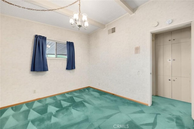 spare room featuring carpet floors, visible vents, an inviting chandelier, beamed ceiling, and baseboards