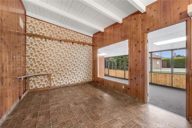 unfurnished sunroom with lofted ceiling with beams