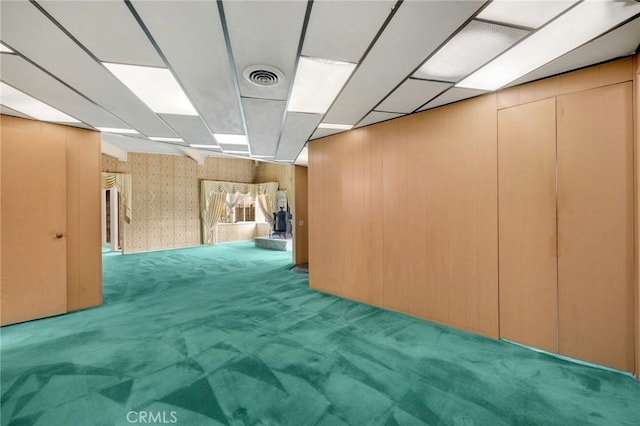 interior space with carpet, visible vents, and a drop ceiling