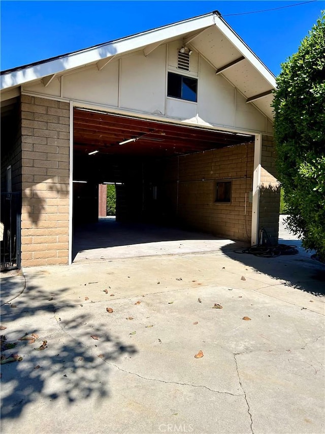 view of side of property with a garage and brick siding