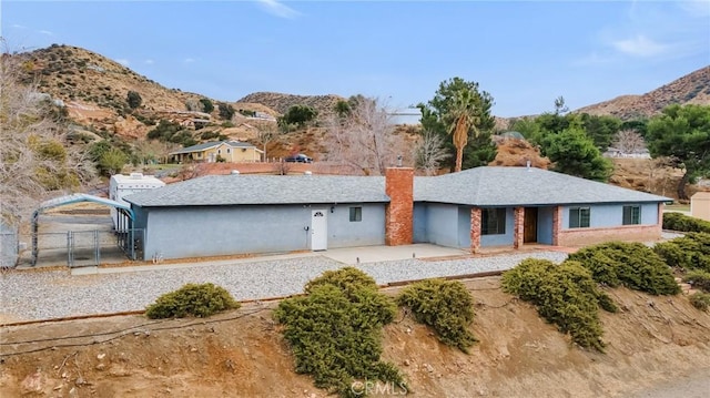 view of front of home featuring a gate, a mountain view, a patio, and fence