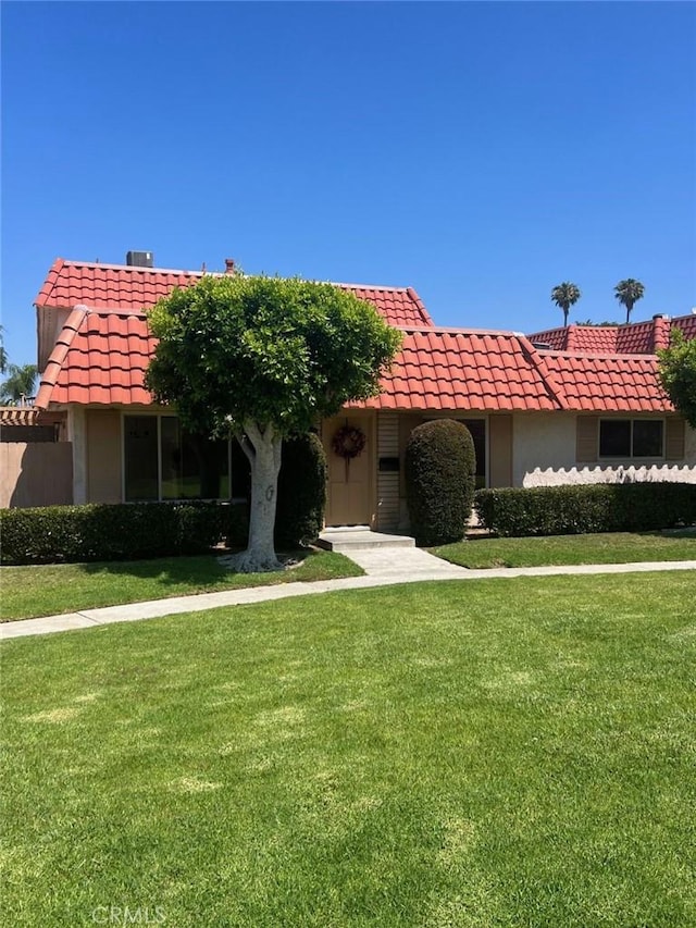 22822 Mesa Way Unit 1, Lake Forest, CA 92630 - view of front of house featuring a tiled roof, a front yard, and stucco siding