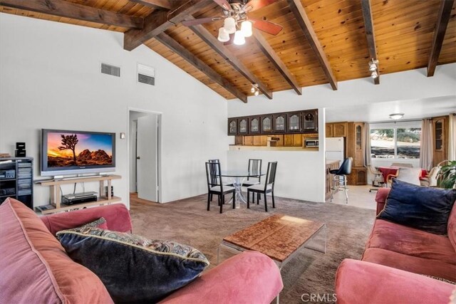 living area with wooden ceiling, beamed ceiling, carpet, and visible vents