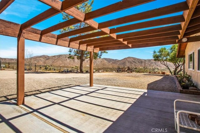 view of patio featuring a mountain view and a pergola