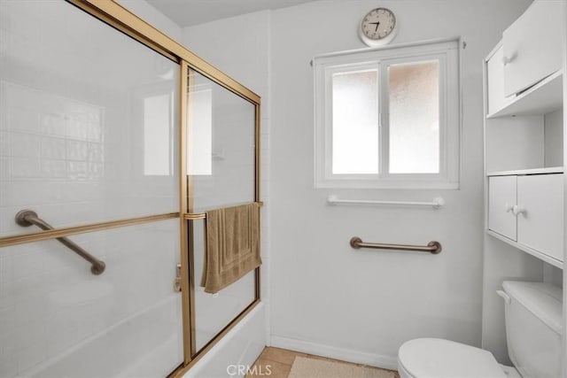 full bathroom featuring toilet, enclosed tub / shower combo, and baseboards