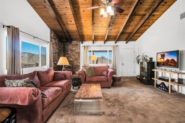 living area with a wood stove, wooden ceiling, beam ceiling, and carpet flooring