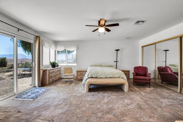 carpeted bedroom with ceiling fan, a closet, visible vents, and access to exterior