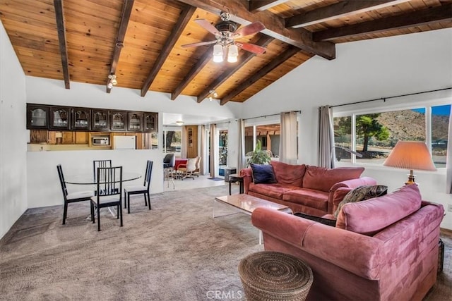 living area with carpet floors, wood ceiling, lofted ceiling with beams, and a ceiling fan