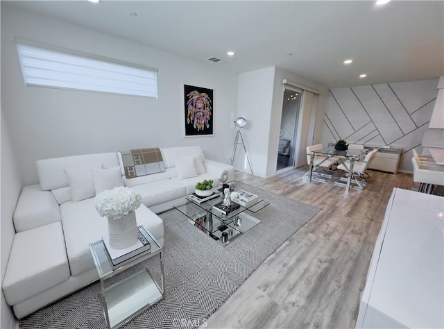 living room featuring recessed lighting, wood finished floors, and visible vents