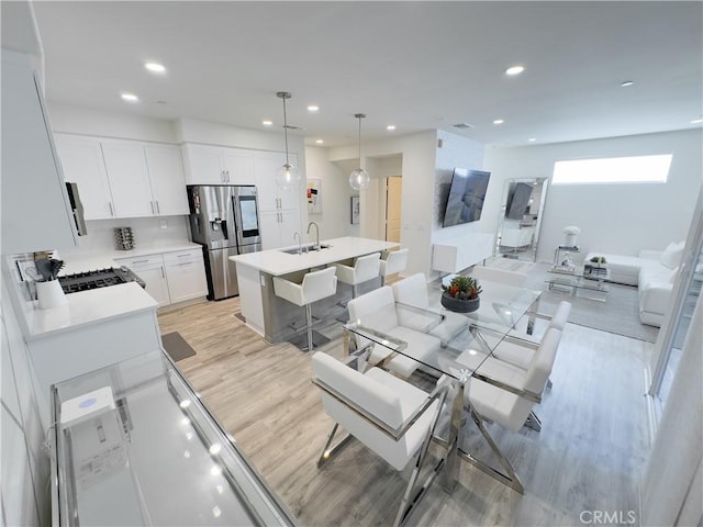 dining area featuring recessed lighting and light wood-type flooring