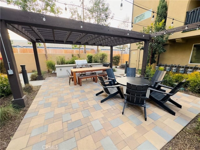 view of patio with outdoor dining space, fence, and a pergola