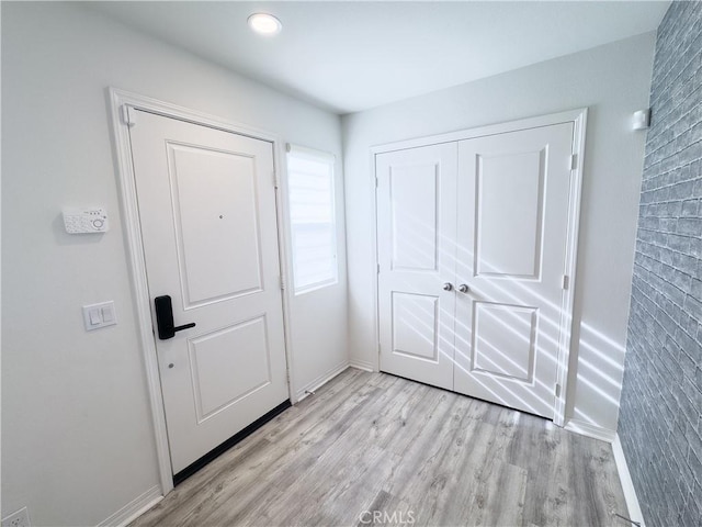 entrance foyer with light wood finished floors and baseboards