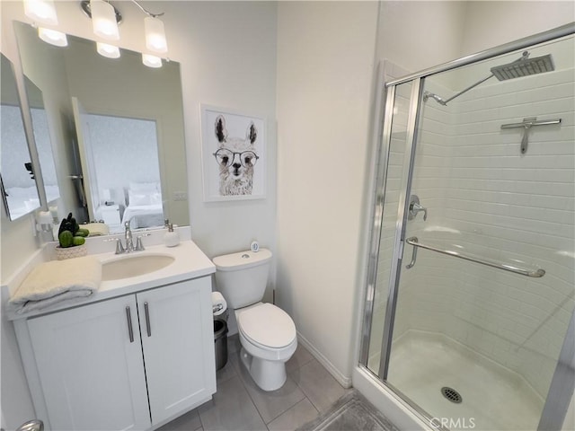 ensuite bathroom with vanity, a shower stall, toilet, and ensuite bathroom