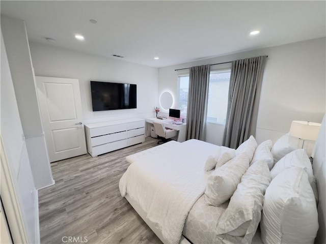 bedroom with recessed lighting, visible vents, and light wood finished floors