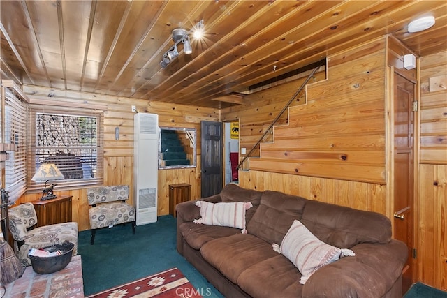 living area with carpet, wooden ceiling, wood walls, and stairs