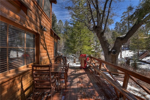 wooden terrace with a grill