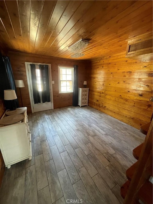 interior space with wood walls, wood ceiling, and wood finished floors