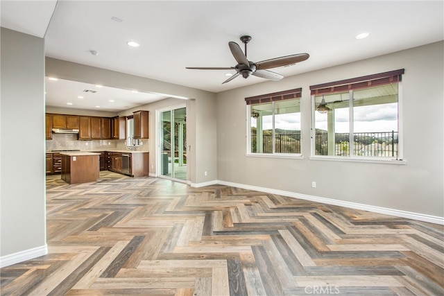 unfurnished living room featuring a ceiling fan, recessed lighting, and baseboards