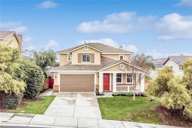 traditional-style home featuring a garage, concrete driveway, a tiled roof, stucco siding, and a front yard