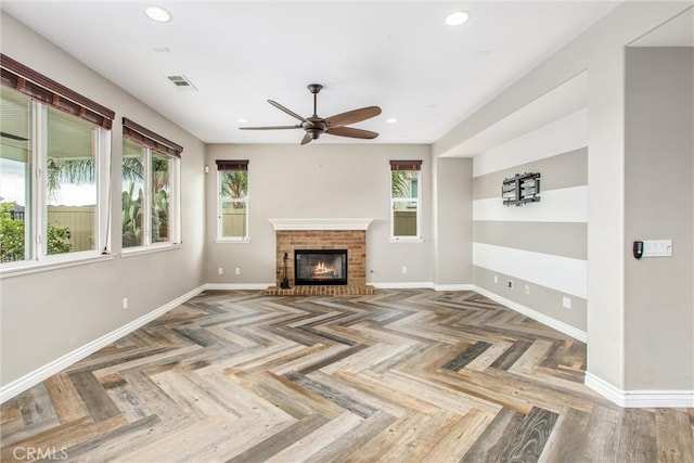 unfurnished living room featuring baseboards, a wealth of natural light, and recessed lighting