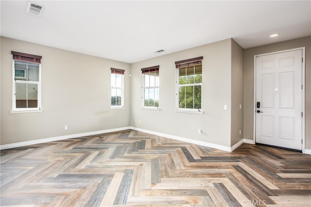 spare room featuring baseboards and visible vents