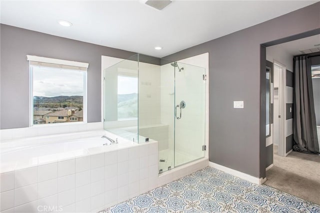 full bath with plenty of natural light, a shower stall, baseboards, and a bath