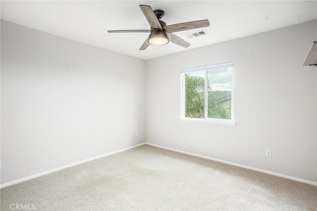 unfurnished room with baseboards, visible vents, a ceiling fan, and light colored carpet