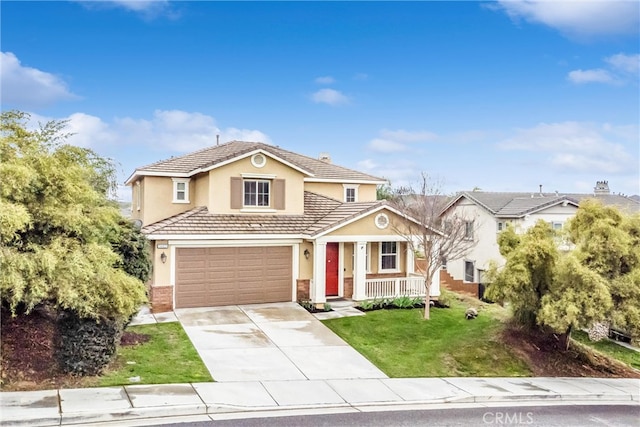 traditional home with stucco siding, a porch, a front yard, driveway, and a tiled roof