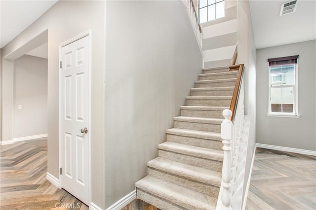 stairs featuring visible vents and baseboards