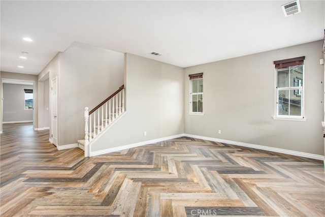 empty room featuring stairway, baseboards, visible vents, and recessed lighting