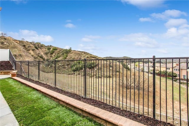 view of gate featuring fence and a mountain view