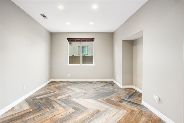 spare room featuring recessed lighting, visible vents, and baseboards