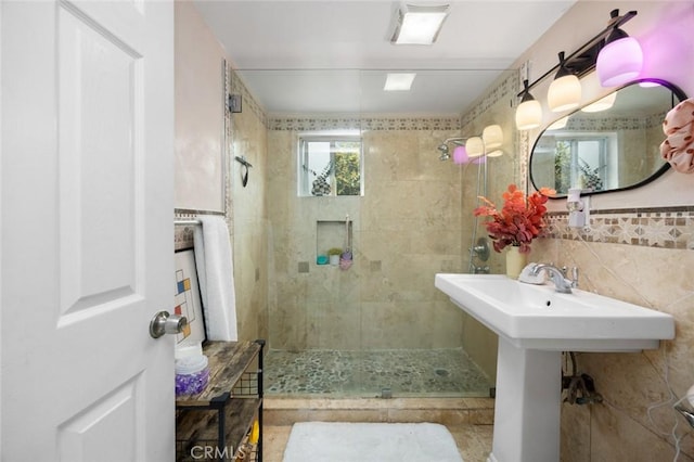 full bath featuring a shower stall and tile walls